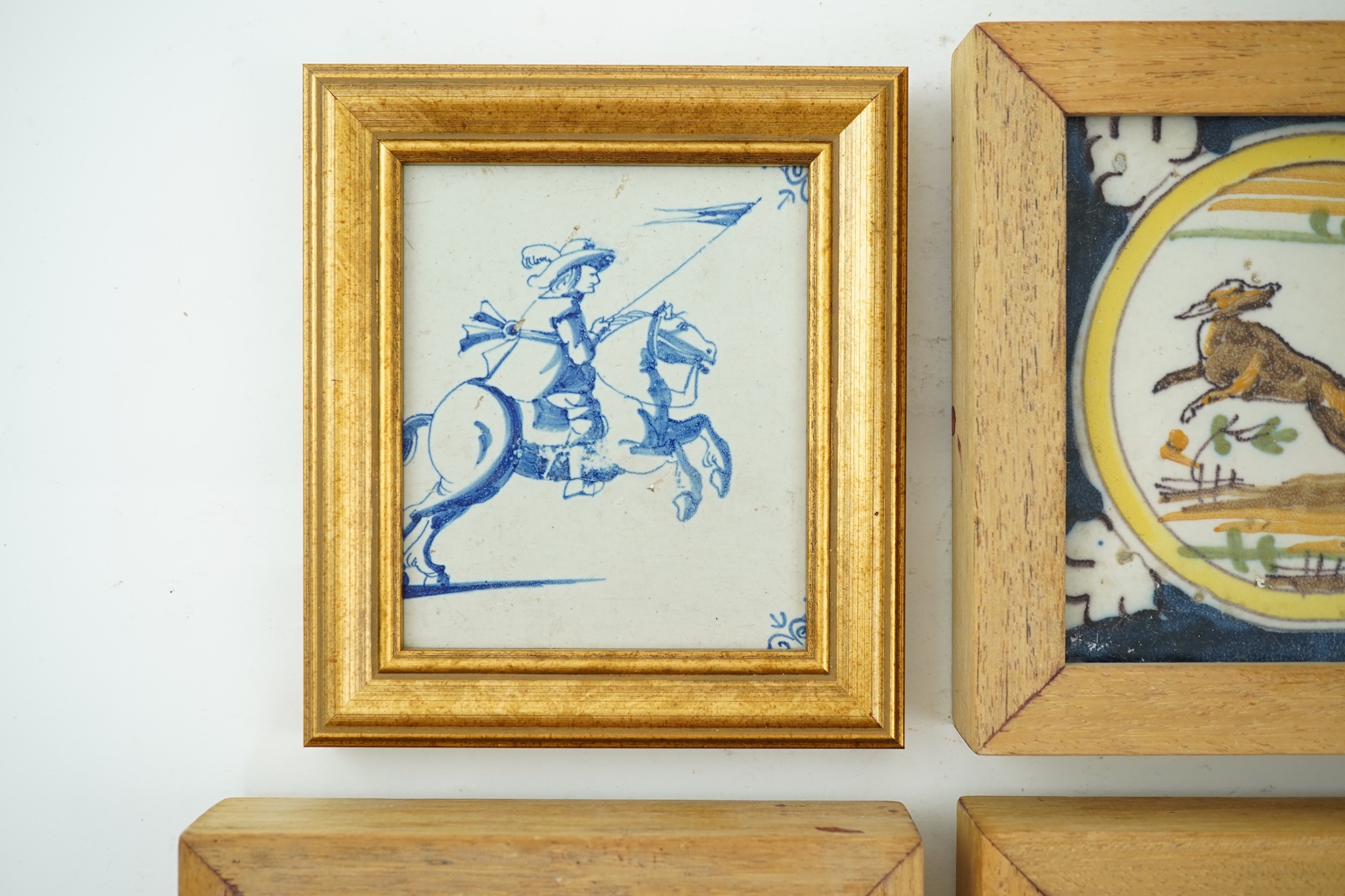 Three Spanish polychrome maiolica ‘animal’ tiles, Triana, early 18th century and a Delft blue and white tile, 19th century